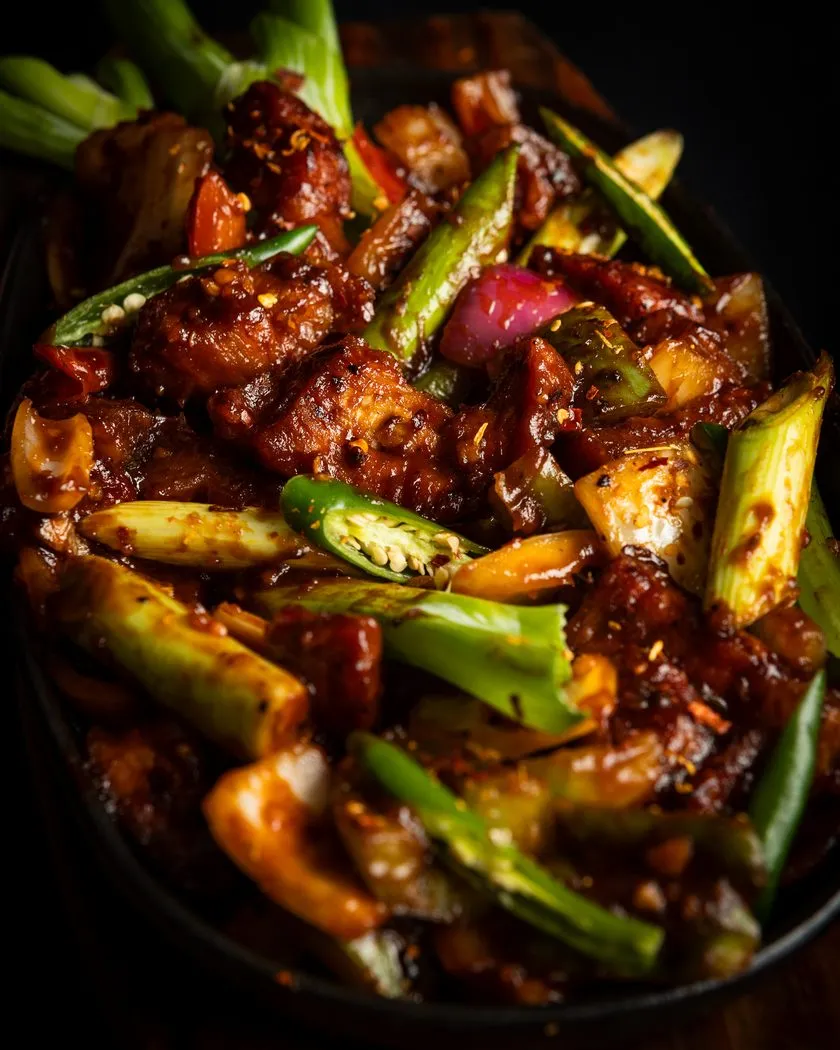Close-up of a sizzling Sri Lankan devilled stir fry with chilli, capsicum and onion