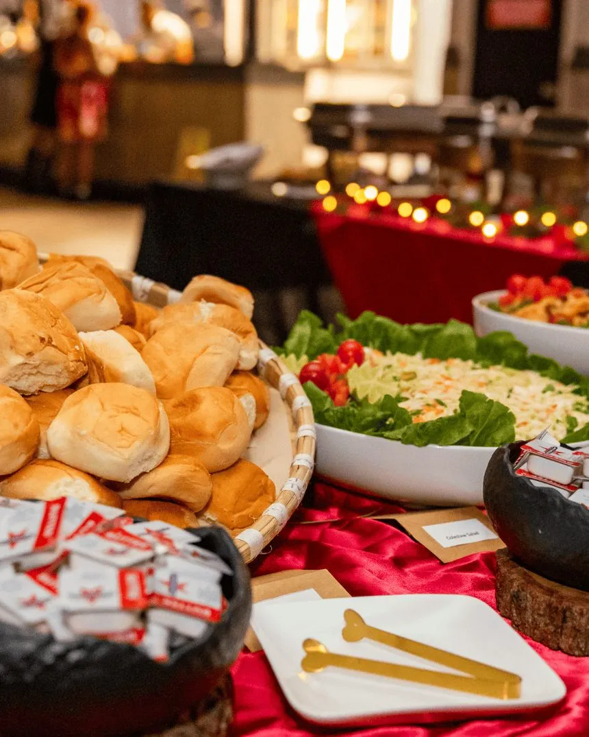 Bread rolls, salads and curries on a catering spread