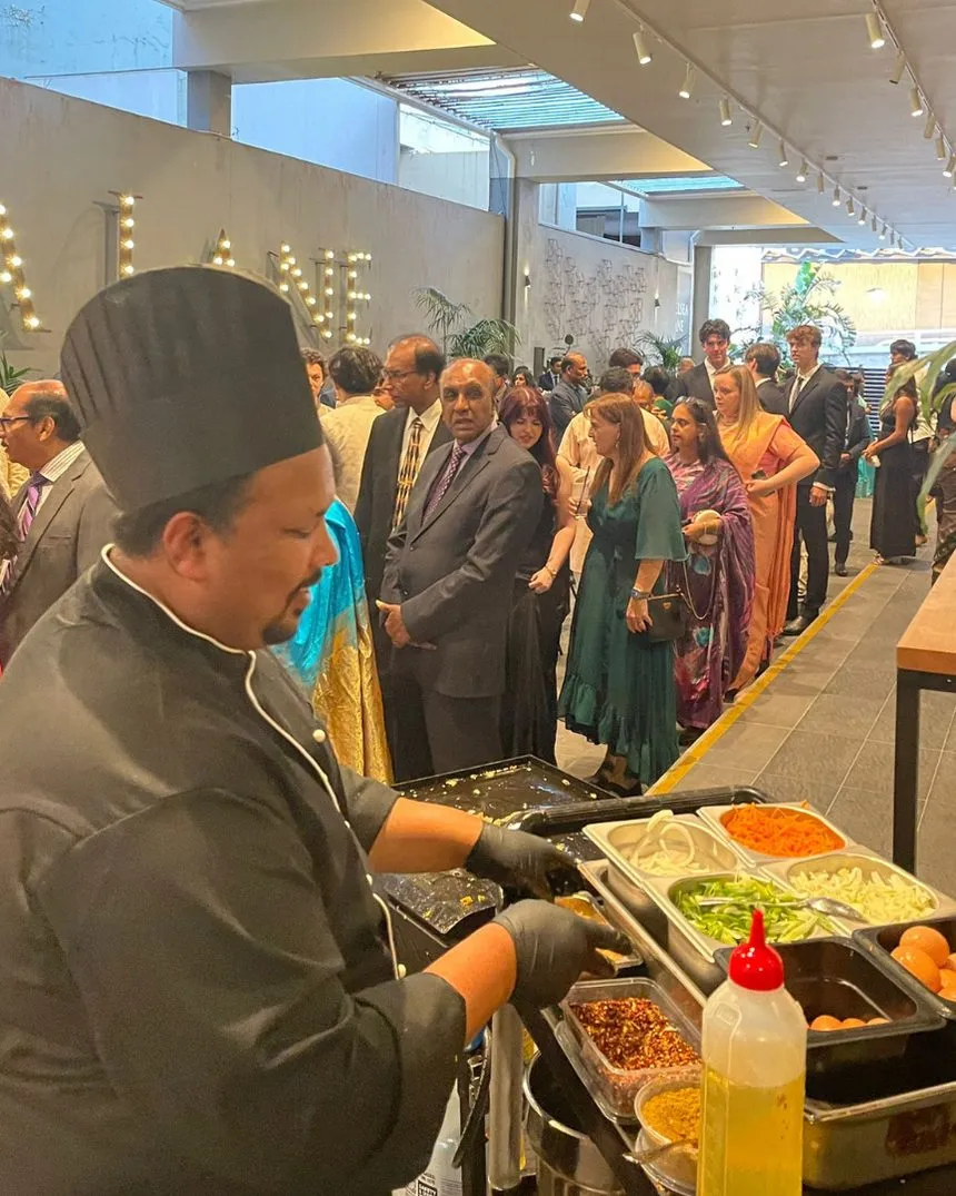 A Walkway to Ceylon chef serving guests at a busy catered event
