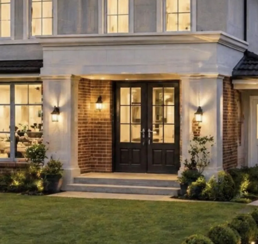 Warm brick entry and front door of a custom home