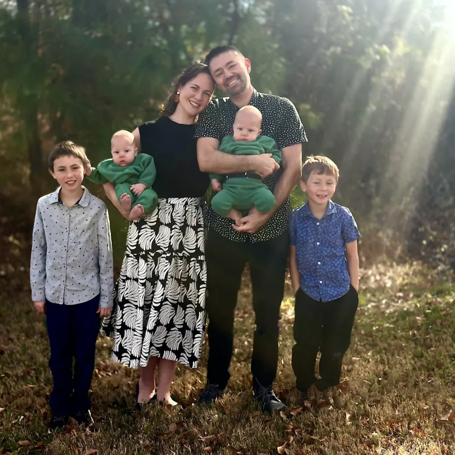 Paul and Ali with their four sons in warm sunlight