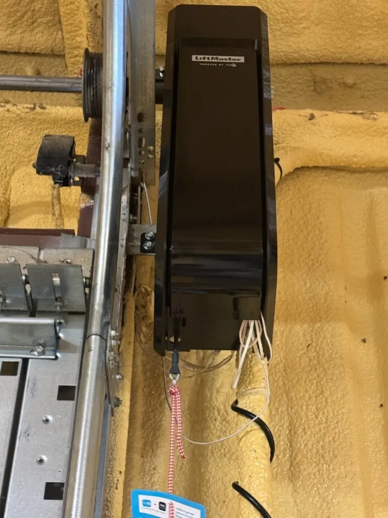 Wall-mount jackshaft opener beside the door track