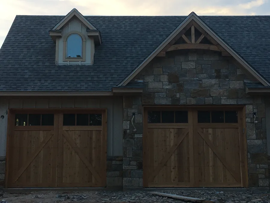 Cedar garage doors on a new stone home