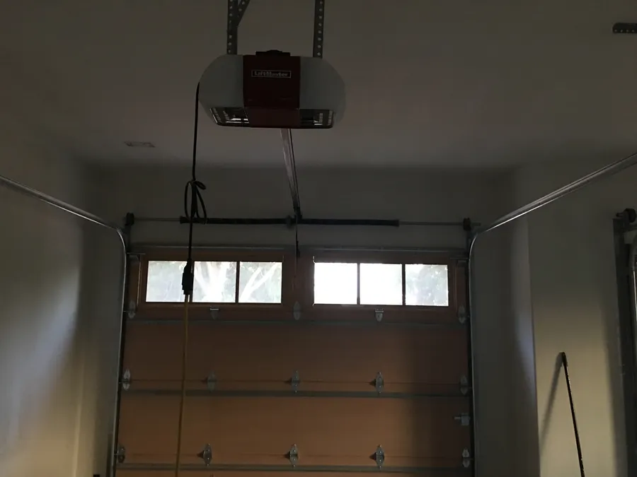 Opener installed over a wood garage door