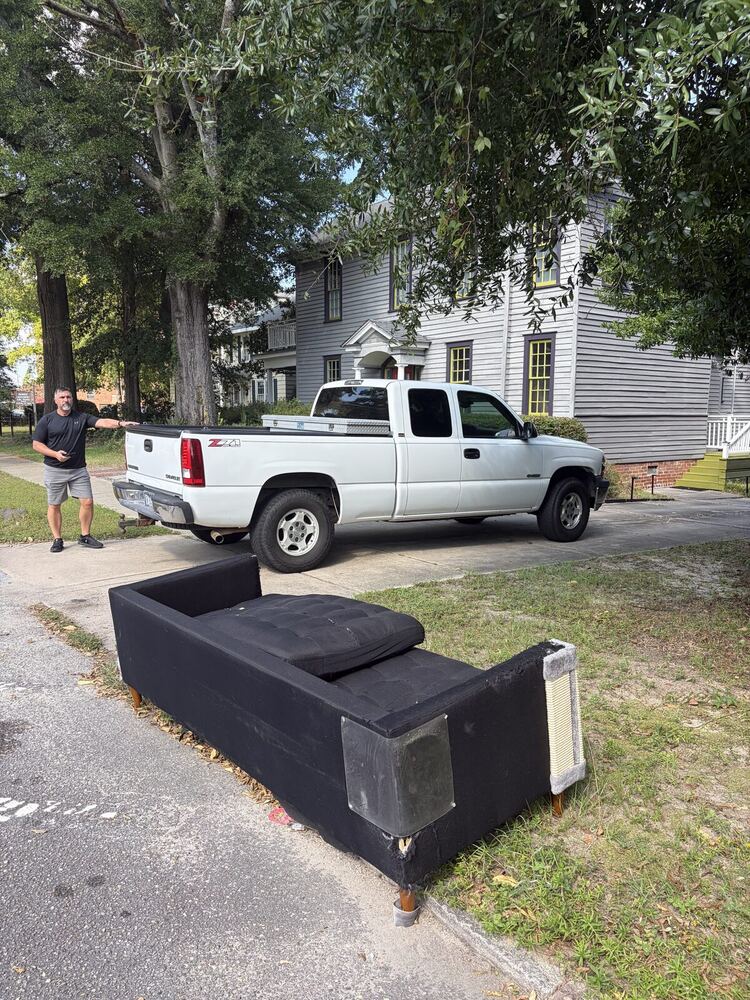 Crew loading couch onto the truck in Fayetteville