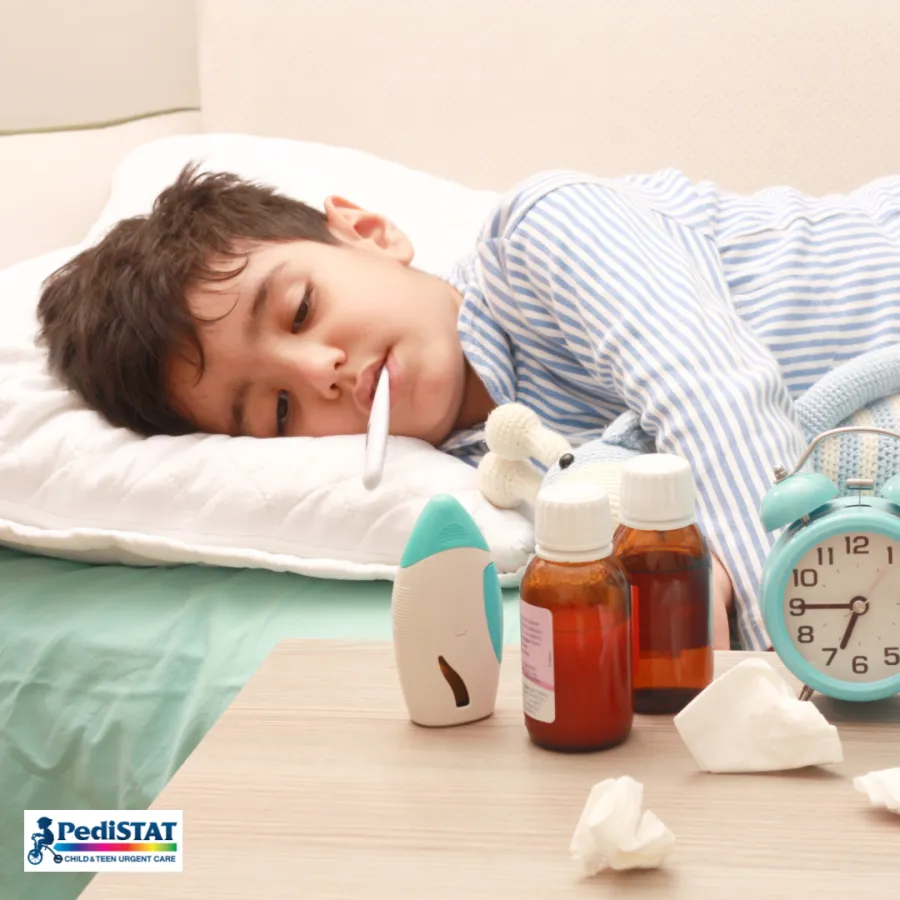 Child resting in bed with a cold, tissues and medicine nearby