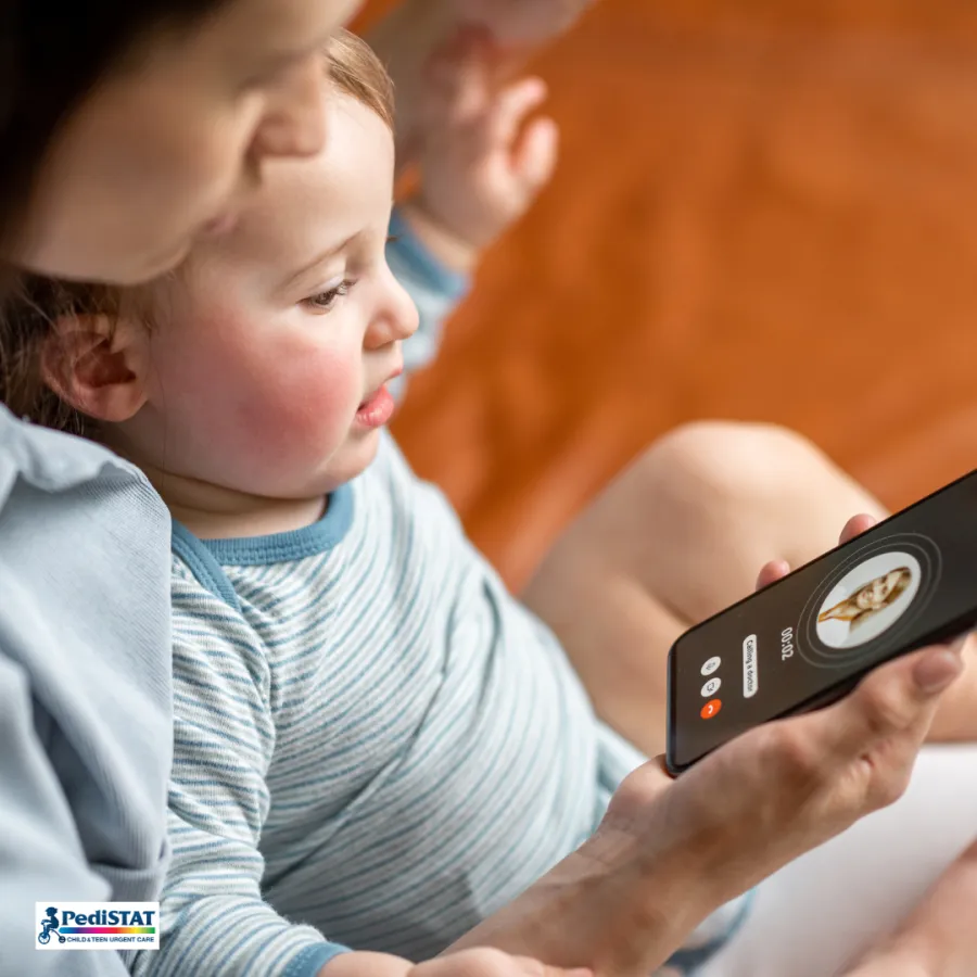 Parent checking a sick child's temperature with a digital thermometer