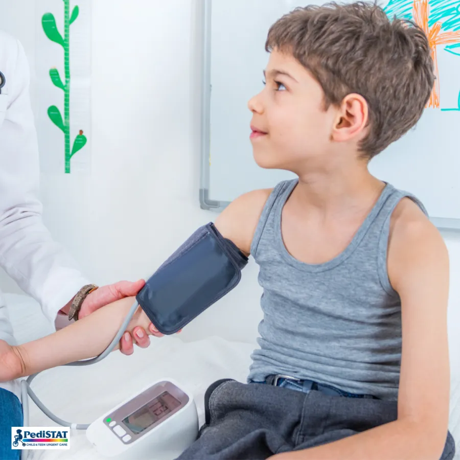 Boy having his blood pressure checked during a sports physical