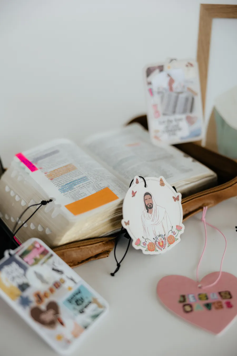 Faith-inspired Scented Hope freshies beside an open Bible