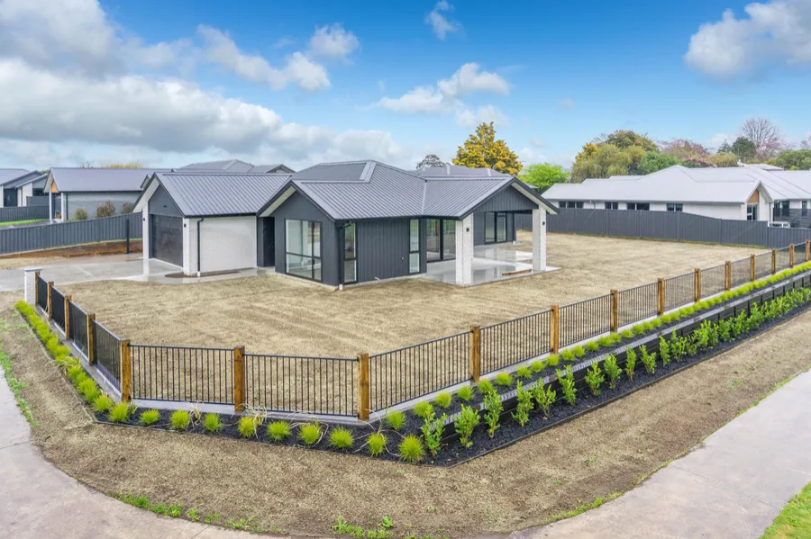 Home with white brick, dark cladding and covered outdoor living built by MH Builders in Lotus Place, Te Awamutu