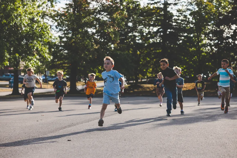 Learners running and playing outside