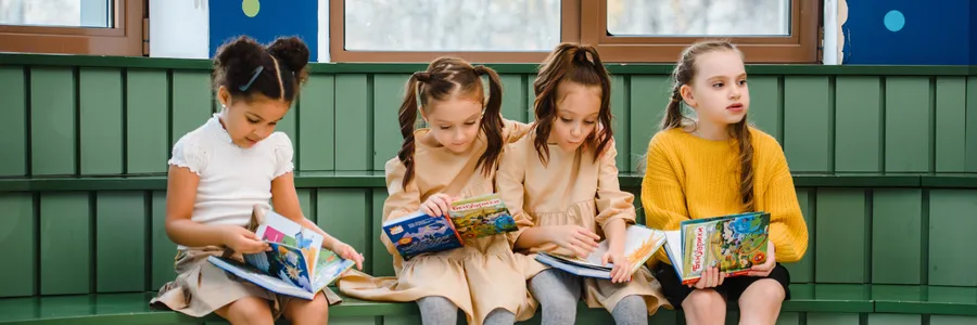 Learners reading on a bench