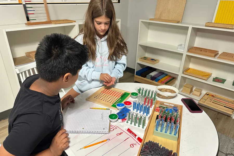 Learners building with materials at a table