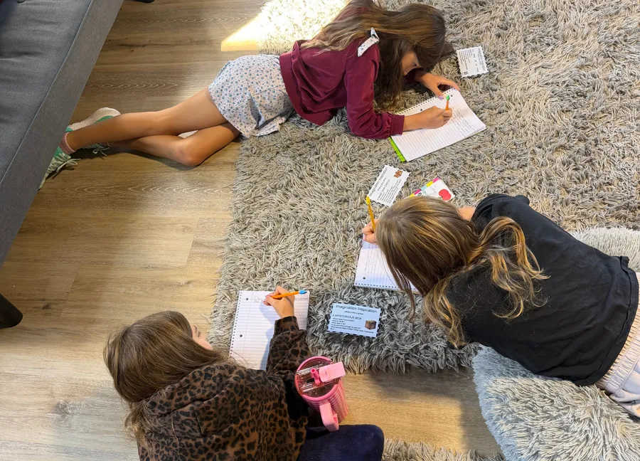 Learners drawing together on the floor