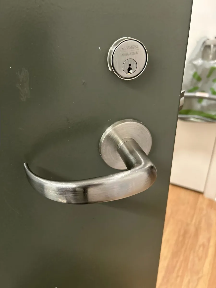 Commercial lever handle and deadbolt on a door