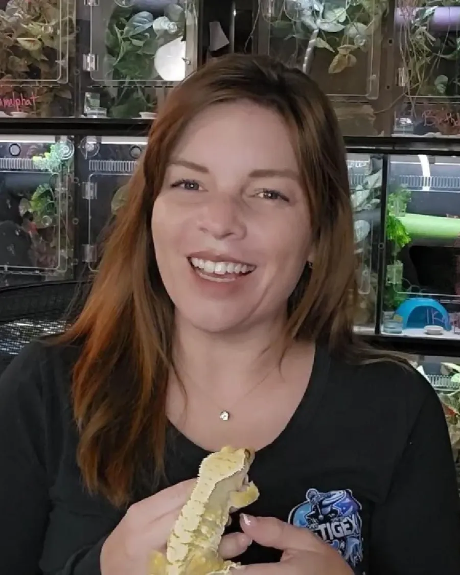 Brianna smiling and holding a crested gecko