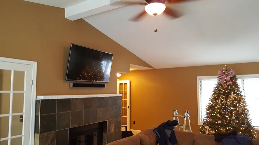 TV mounted on an angled wall above a corner fireplace