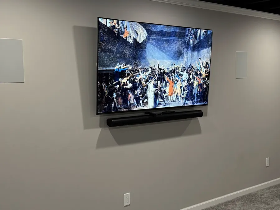 TV with a soundbar and in-wall speakers on each side