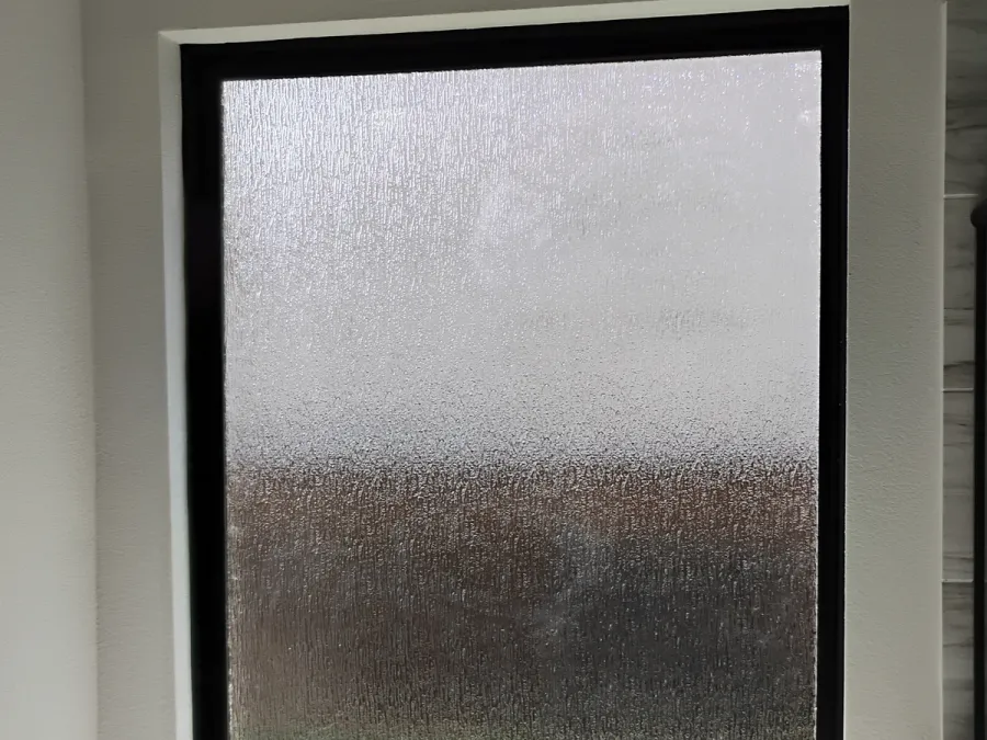 Frosted privacy glass window over a soaking tub, DFW bathroom
