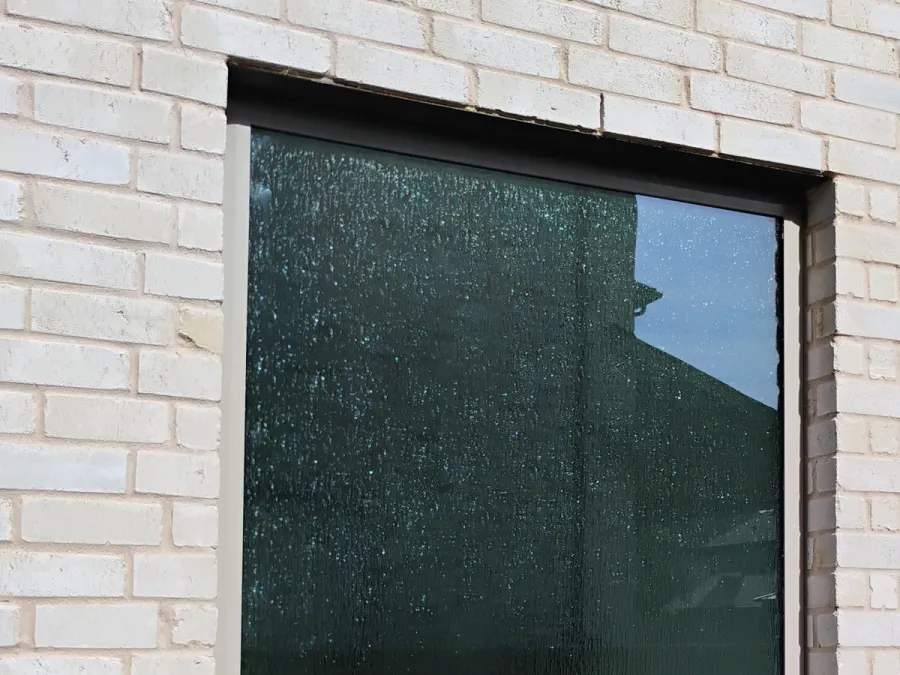 Rain-glass replacement window in a white brick DFW home