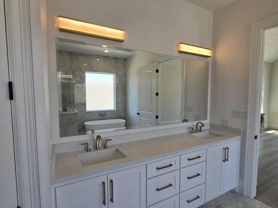 Frameless double-vanity mirror installed in a DFW bathroom