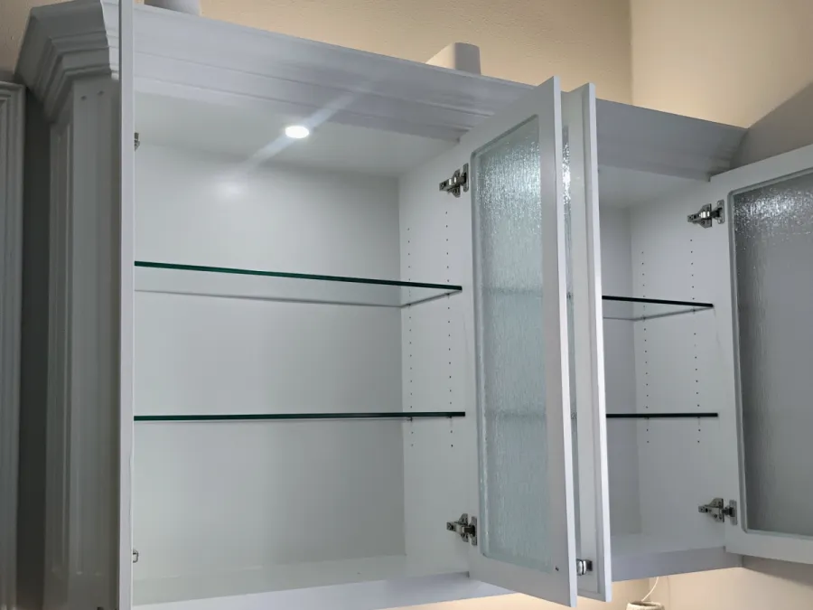 Open cabinet showing glass shelves