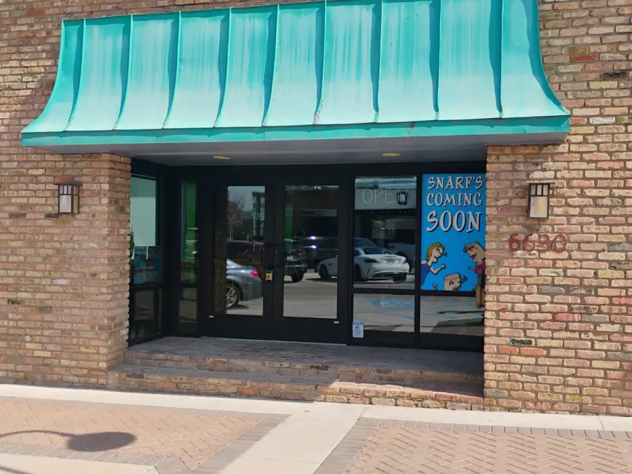 Brick storefront with black aluminum entry
