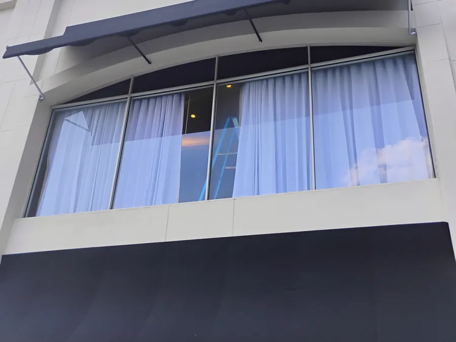 Storefront window run under a curved awning