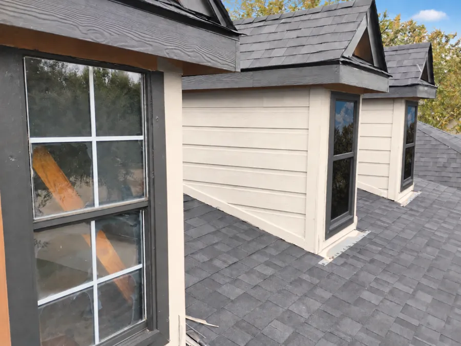 Dormer window replacement in progress on a DFW roof