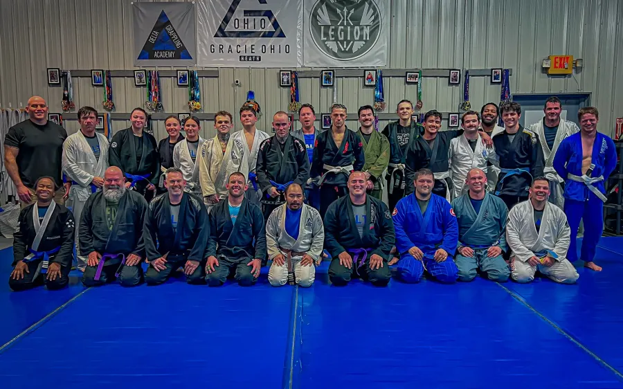 Delta members in a team photo under the Gracie Ohio banner