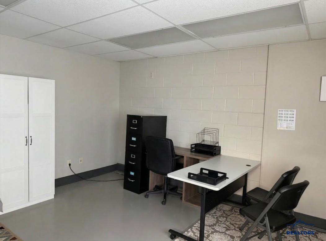 Private office with a desk, a file cabinet and a tall storage cabinet