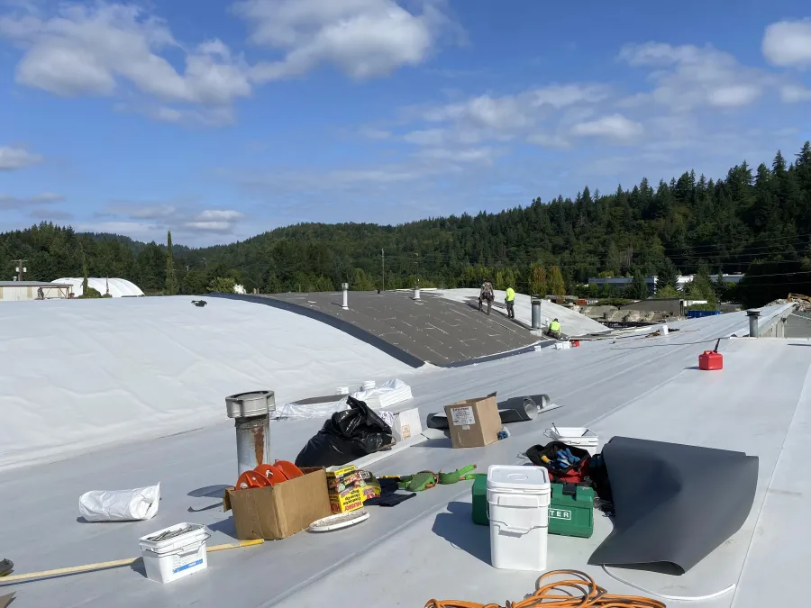 BSR Constructions LLC crew installing a commercial flat roof membrane in the Seattle area