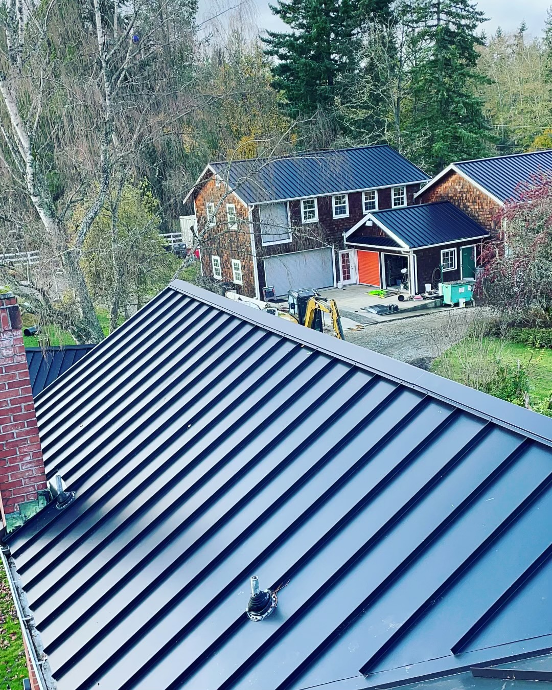 Black standing seam metal roof installed by BSR Constructions LLC on a Seattle area home
