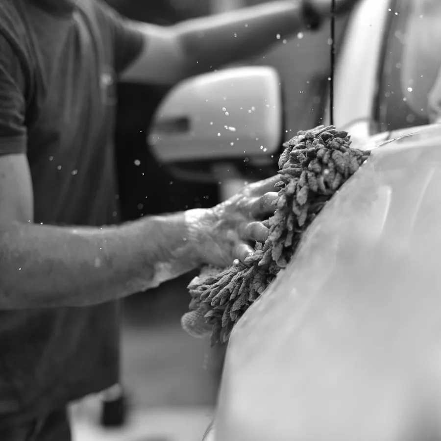Wash mitt on a car door during a hand wash