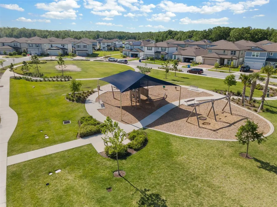 Playground and shaded pavilion on an open lawn in Bexley