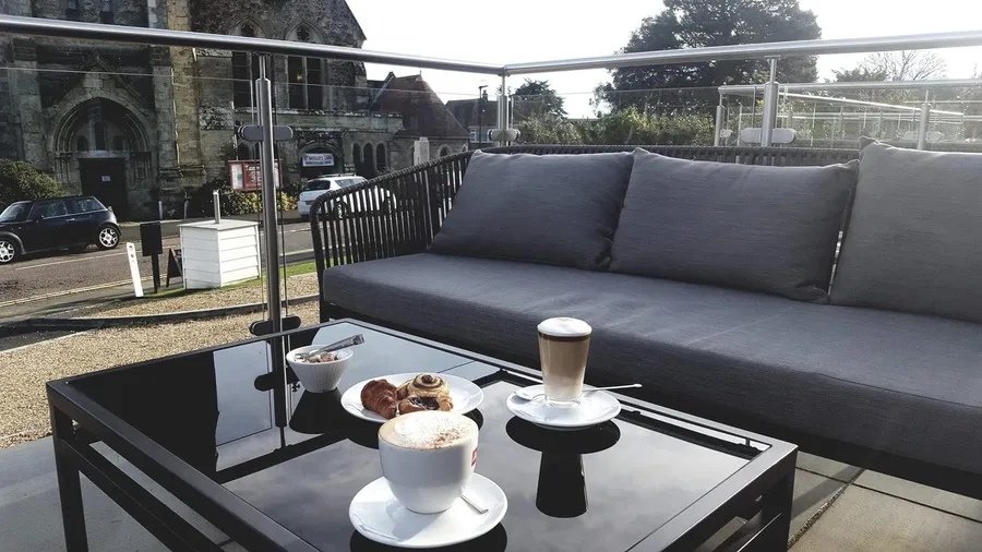 Terrace sofa with coffee and pastries in the sun at The Fig Tree, Shanklin