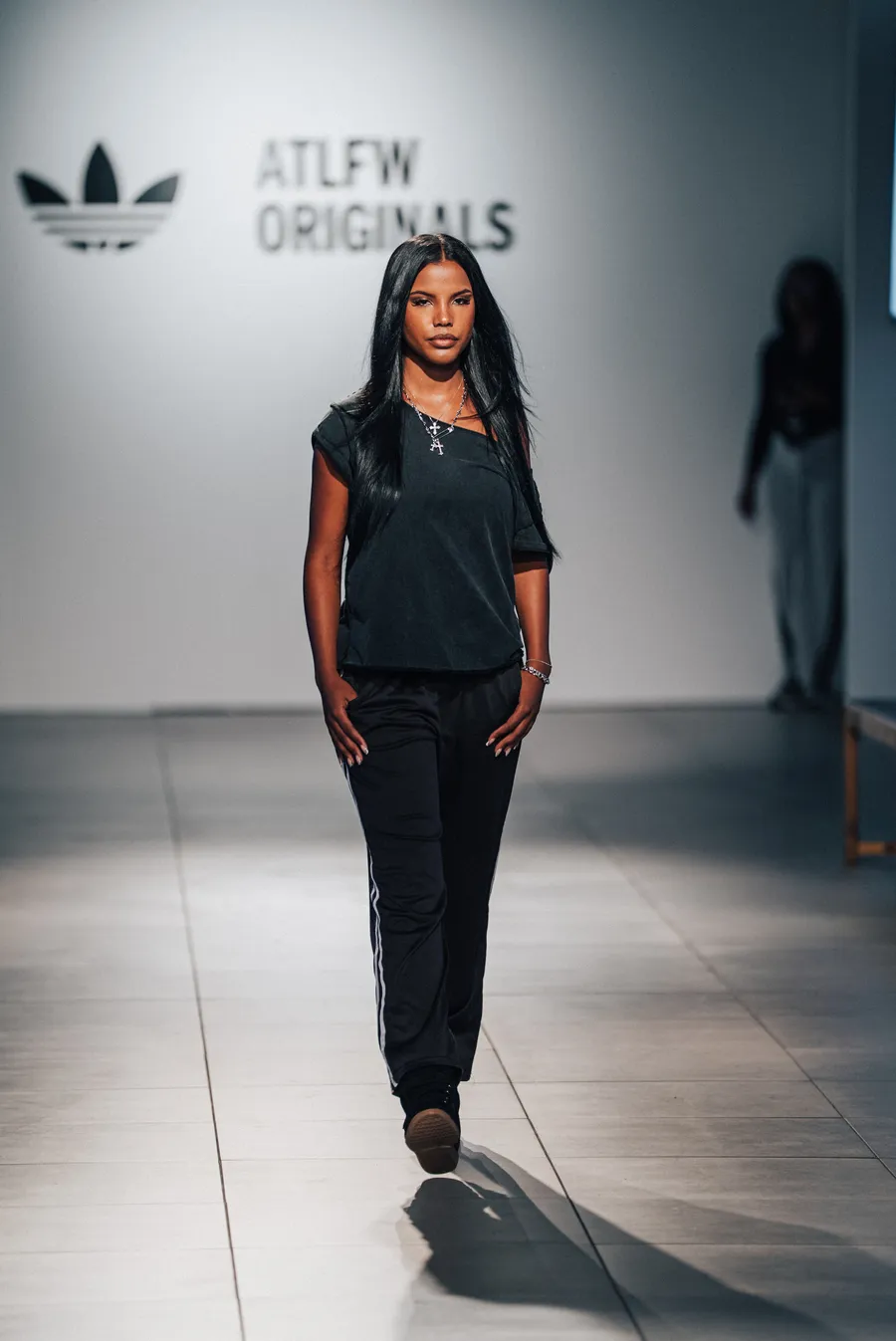 Model in all black under the ATLFW Originals sign