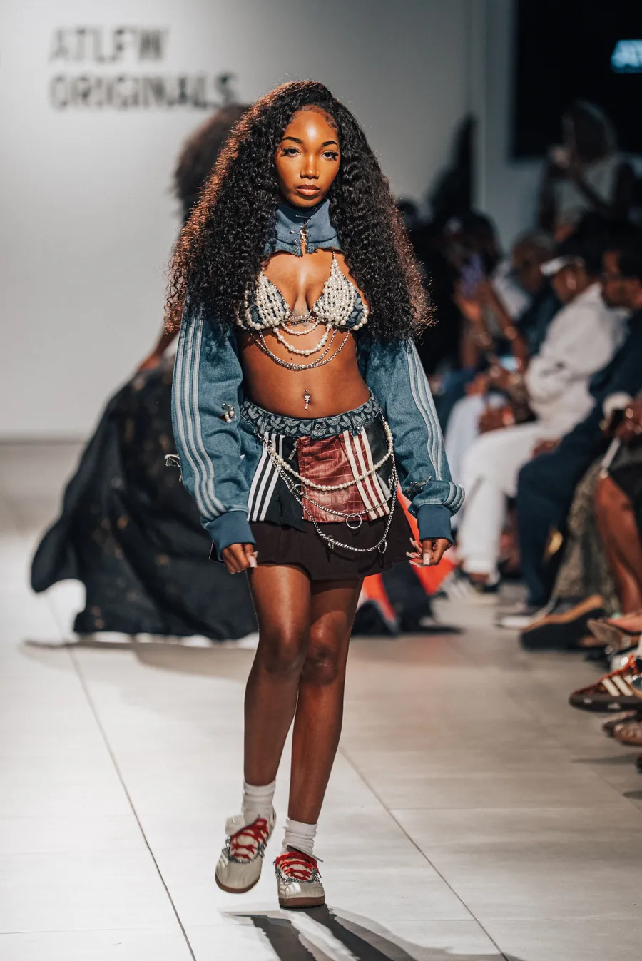 Model in a denim jacket and two-piece on the runway