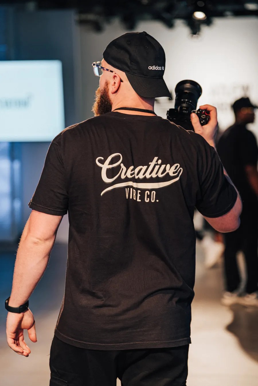 Creative Vibe camera operator walking the runway with a cinema camera