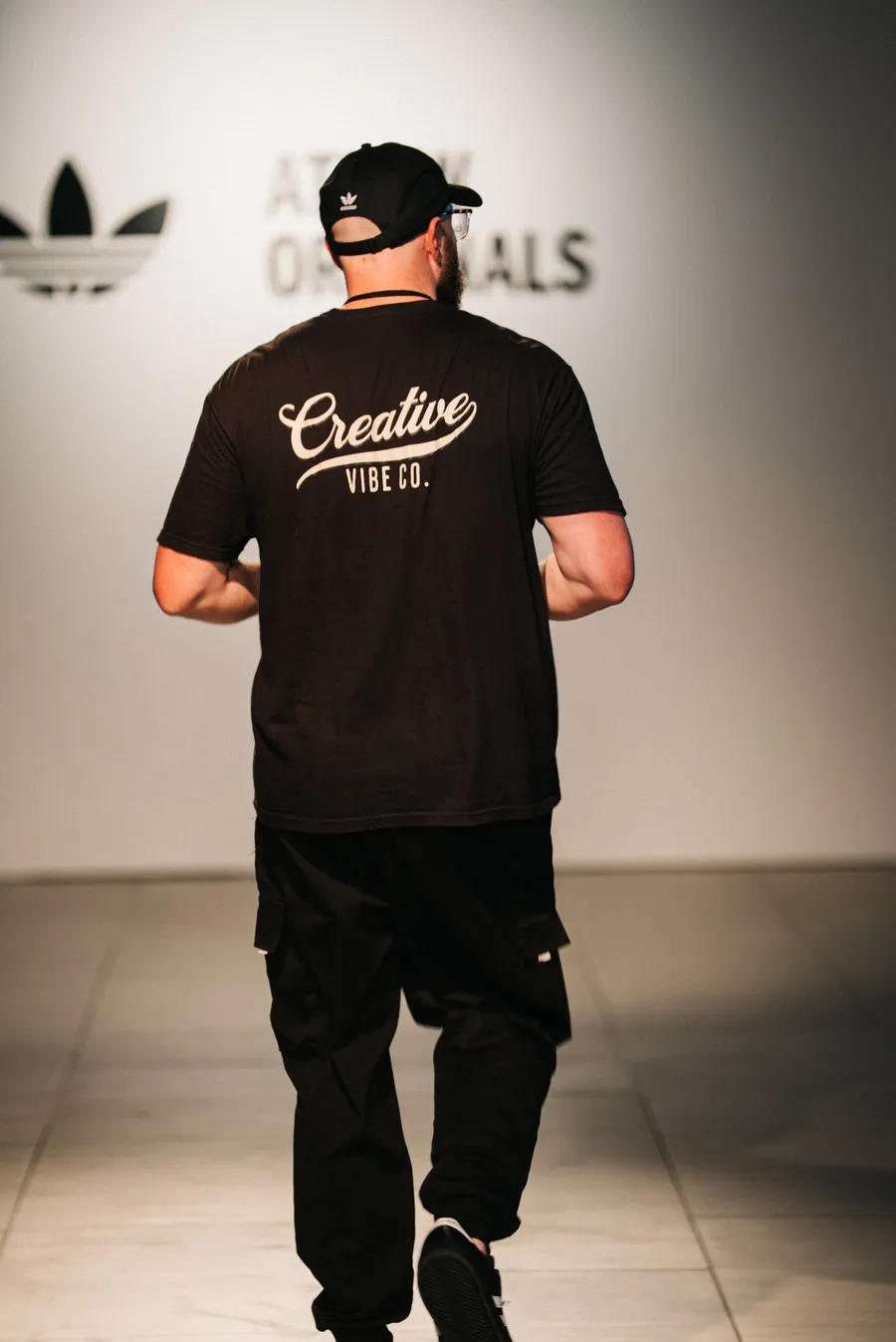 Creative Vibe crew walking the runway under the adidas Originals sign