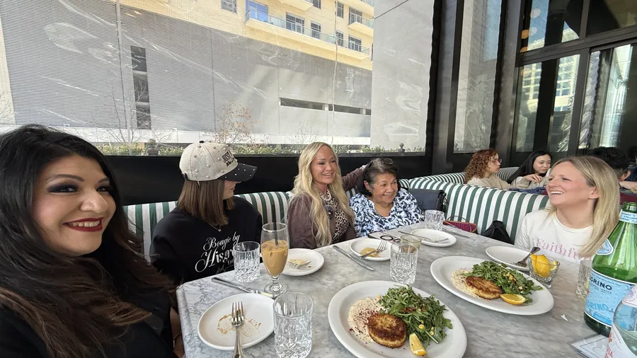 Limitless Ladies sharing a meal together around a restaurant table