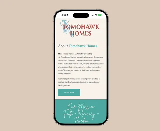 Tomohawk Homes website shown on a phone screen