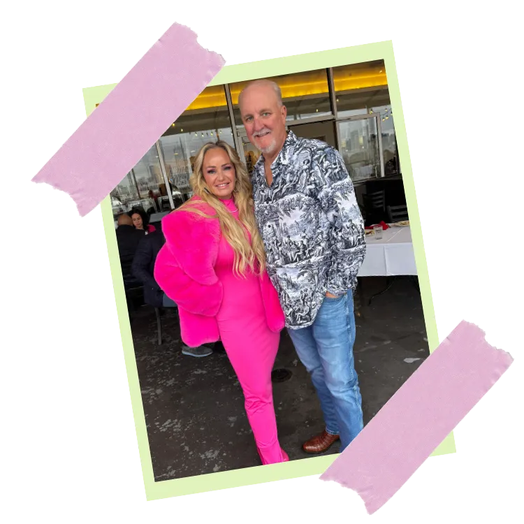Tosha BabyDoll Martin in a pink suit, smiling beside a man in a patterned shirt