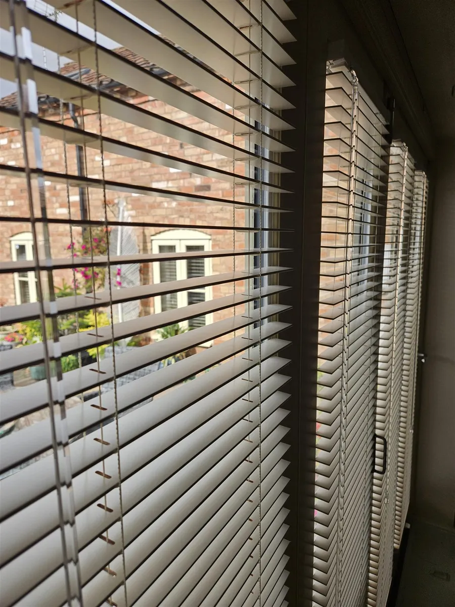 Cream real wood venetian blinds fitted to bi-fold doors by Eclipse SBC in Woodhall Spa
