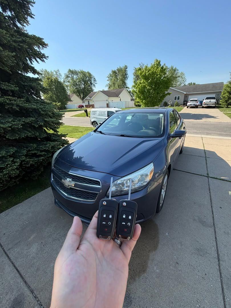 Two flip keys for a blue Chevrolet Malibu