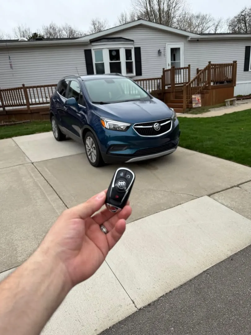 Smart key for a blue Buick Encore in the driveway