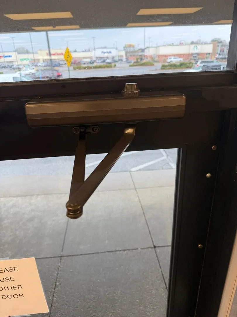 Door closer arm on a commercial door