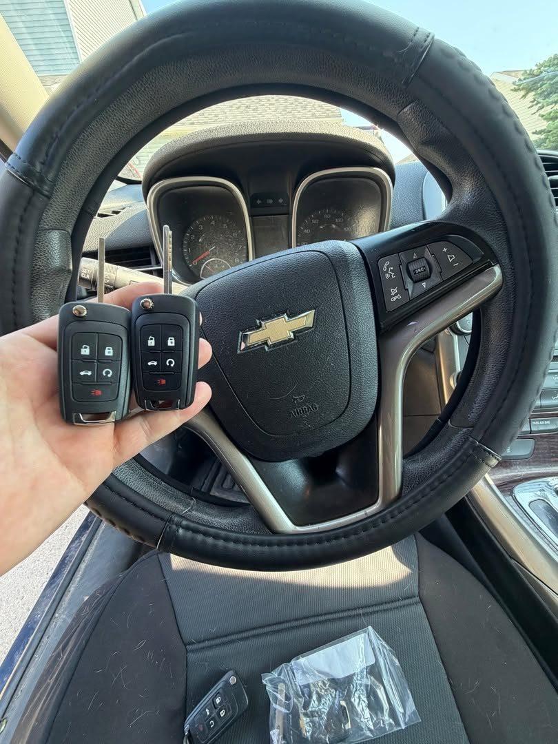 Two Chevrolet flip keys at the steering wheel