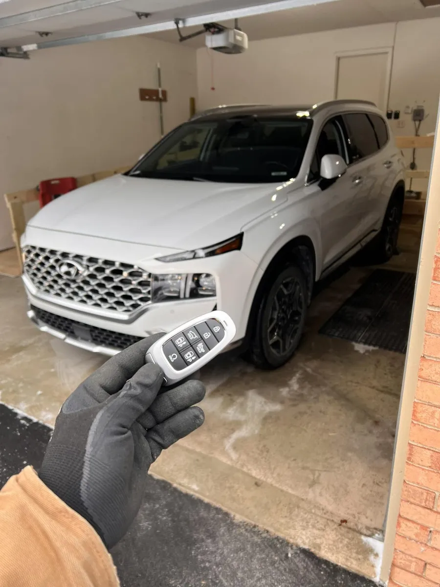 Smart key for a white Hyundai Santa Fe in a garage