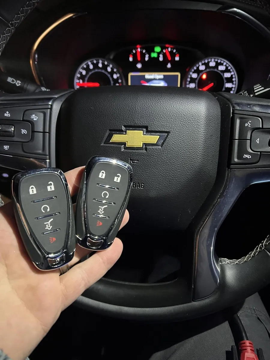 Two Chevrolet smart keys at the steering wheel